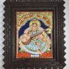 Framed 13x11 inch Saraswathi Tanjore Painting with 22K gold foil and teakwood – traditional Indian artwork for home or gifting.