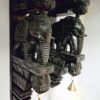 A pair of 18 inch wooden elephant corbels by JLine Arts with an antique look finish. Each hand-carved wall bracket features intricate detailing and hanging brass bells, ideal for door entrance wall decor