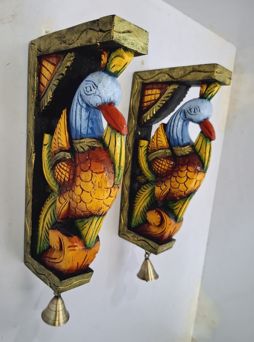 Beautifully hand-painted wooden bird wall brackets (2 pc set) from JLine Arts, showcasing a lively multicolor finish and genuine brass bells. Perfect for adding vibrant charm to entrance or wall decor, ready to ship