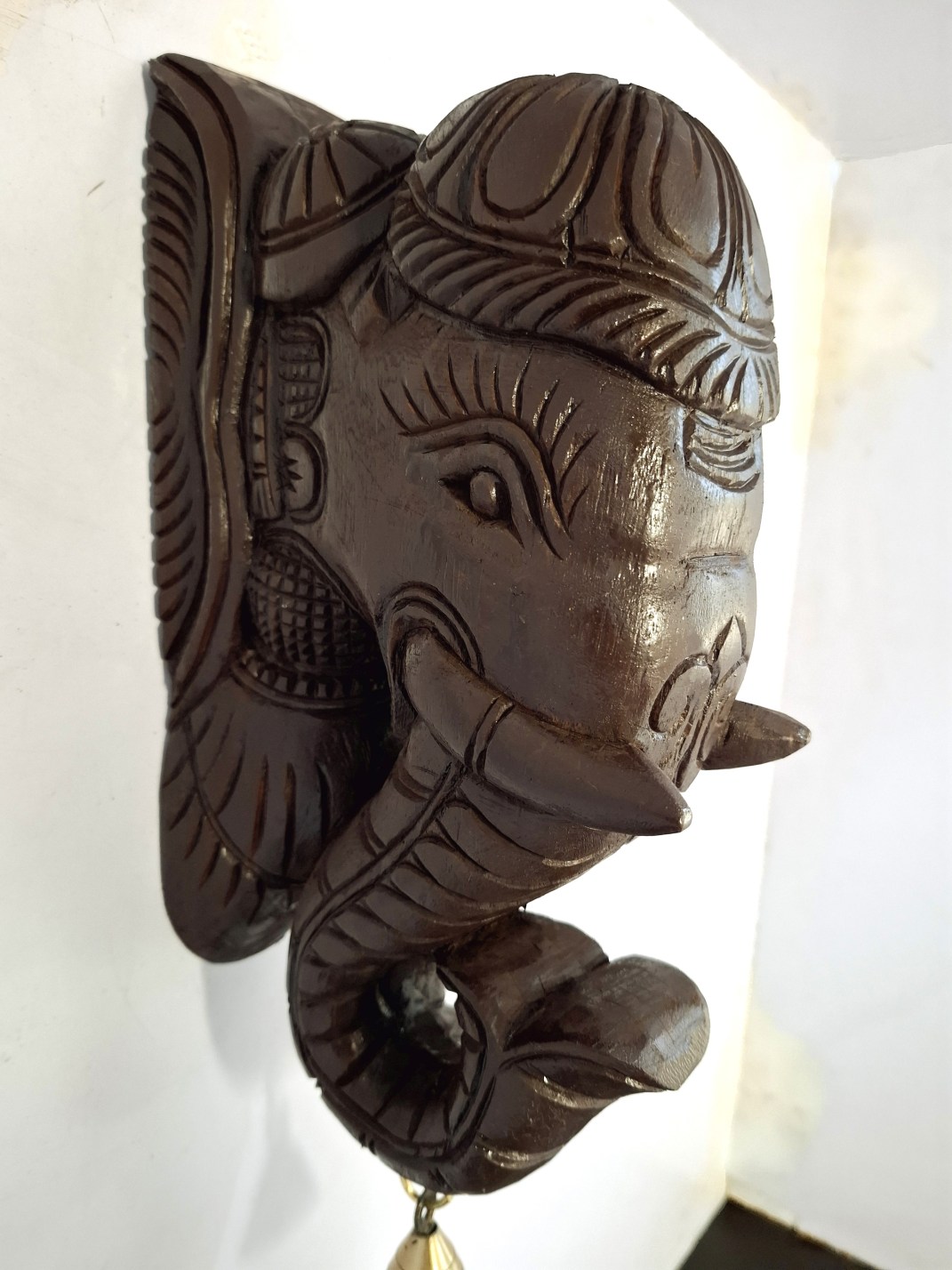 The Wooden Elephant Head Big Corbel, featuring intricate Indian wood carvings and a quality brass bell, complements any Elephant Wall Bracket Pair for a cohesive artistic display.