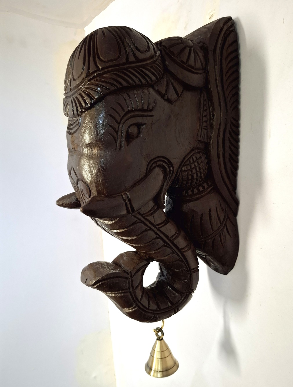 The Wooden Elephant Head Big Corbel, with intricate Indian wood carving and a quality brass bell, makes an elegant wall hanging. Its perfect as a decorative bracket pair to add charm and vintage artistic flair to your space.