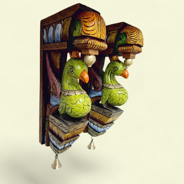 A pair of 18x10x3 inch wooden peacock wall corbels by JLine Arts, hand-carved with a vintage style and hanging brass bells. These ornate wall brackets are perfect for door entrance decor or as decorative wall hangings.