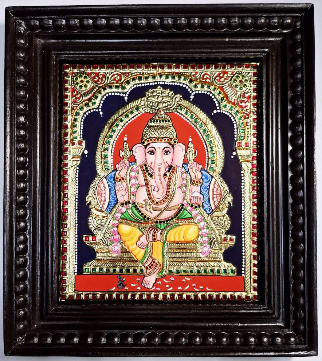 Handcrafted Ganesha Tanjore Painting with 22K gold foil and Jaipur gemstones, set in a premium teakwood frame, size 15x13 inches. Authentic South Indian artwork, perfect for pooja room, home décor, or gifting. Traditional Thanjavur painting by skilled artisans, featuring divine detailing, vibrant colors, and long-lasting craftsmanship.
