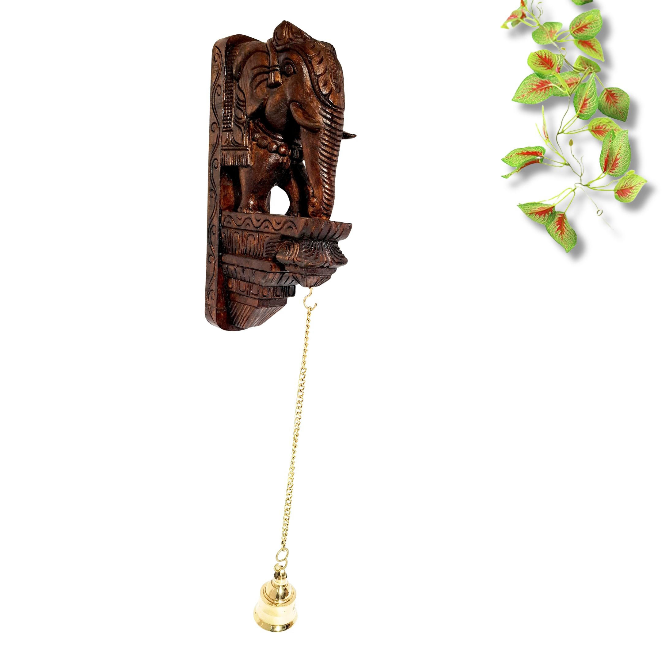 25-inch hand-carved wooden elephant wall bracket with brass bell and chain in antique brown finish, traditional South Indian temple décor.