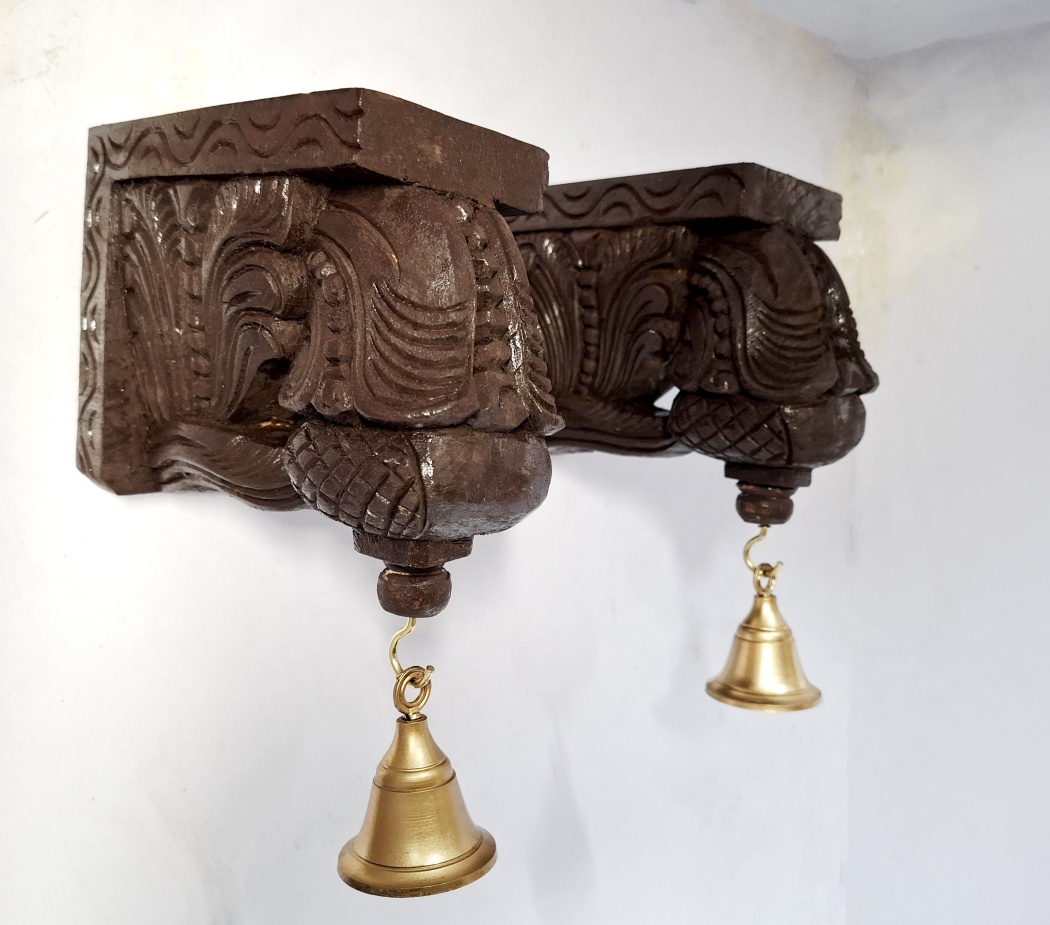 Pair of 7-inch handmade wooden Bodhil wall brackets with antique finish and hanging brass bells, perfect for traditional Indian wall décor.