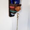 27-inch multicolor hand-carved wooden elephant wall bracket with brass peacock diya and hanging chain, South Indian temple-style wall décor.